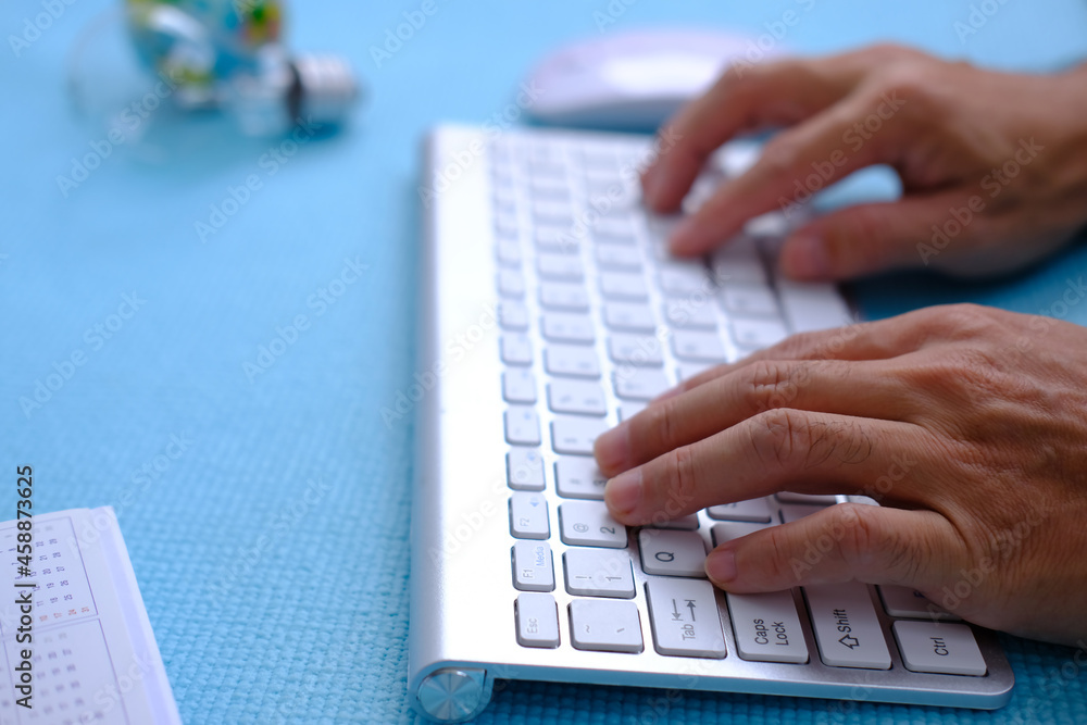 Poster hand working computer on table, top view on working space with office equipment
