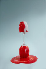 Laboratory liquid flows down on the glass red and white colors milk and blood concept

