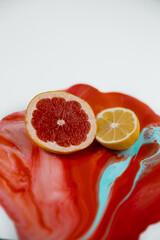 Half of lemon ang grapefruit on the color juice with juicy liquid are flowing down  - 458873874