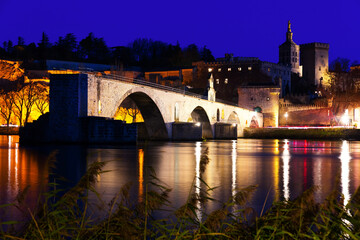 Pont Saint-Benezet and catholic Cathedral in Avignon in night lights, France