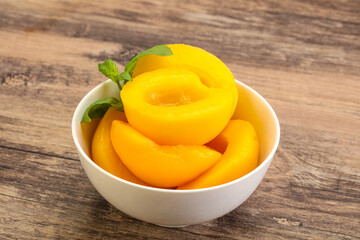 Sweet ripe canned peaches with mint