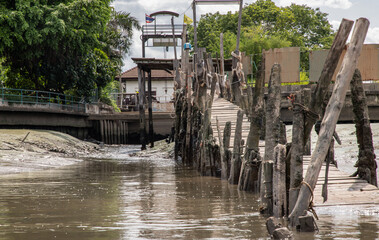Fototapeta na wymiar A view of The old broken wooden pier by Chao Phraya River.