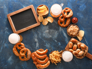 Mug of cold beer, wooden boards with Bavarian sausages and snacks on blue background. Oktoberfest celebration