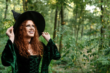 Young witch in green forest