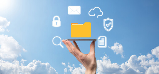 Document Management System DMS .Businessman hold folder and document icon.Software for archiving, searching and managing corporate files and information.Internet Technology Concept.Digital security
