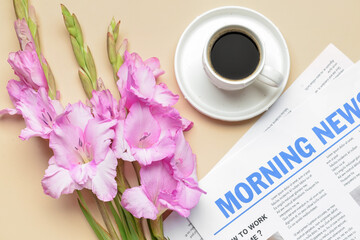 Beautiful gladiolus flowers, cup of coffee and newspaper on color background, closeup