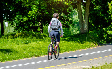 Naklejka premium Cyclist ride on the bike path in the city Park 