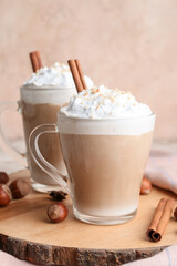 Glass cups of tasty latte with nuts on table
