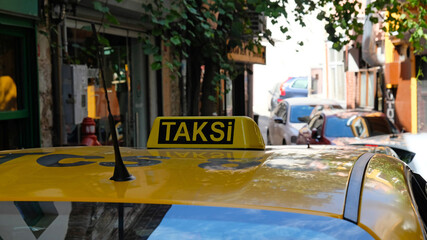 Yellow taxi in Istanbul, Turkey. Close up of a taxi sign. The word 