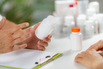 Quantum Medicine. Doctor Holding a Supplement Bottle, recommending supplements to a client.