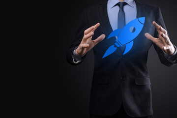 Start up concept with businessman holding abstract digital rocket icon rocket is launching and soar flying