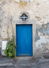 Fototapeta na wymiar Blue door in an old stone house. France