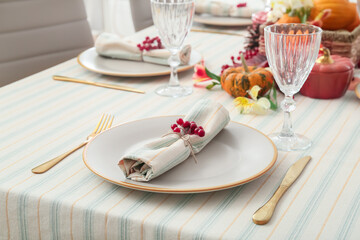 Autumn table serving with rowan, cutlery and glass in restaurant