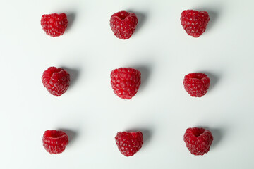Flat lay composition with  red juicy raspberries on a white background