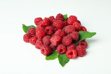 A handful of red juicy raspberries on a white background, close up