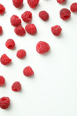 Red juicy raspberries on a white background, space for text
