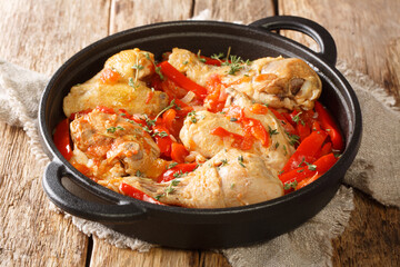 Basque Chicken or Poulet Basquaise with vegetables close up in the pan on the table. Horizontal