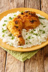 Ayam Percik Coconut Spiced Chicken with rice close up in the plate on the table. Vertical