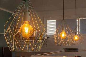 Closeup shot of hanged dim lights with basket-like metal framing