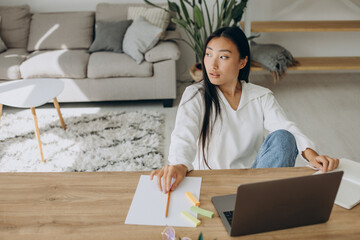 Woman working on computer at the desk from home