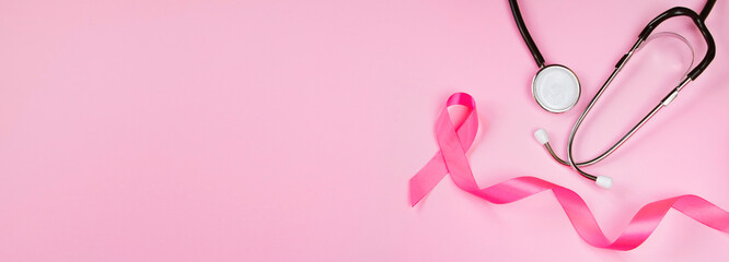 Breast Cancer Awareness Month. Pink ribbon and stethoscope on colored background. Women's health care concept. Symbol of fight against oncology.