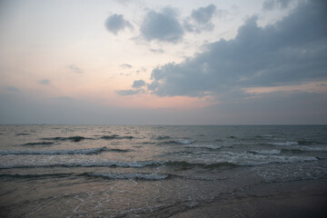 Nature in twilight period which including of sunrise over the sea and the nice beach. Summer beach with blue water and purple sky at the sunset.	

