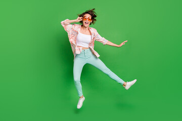 Full size photo of excited joyful happy woman jump up wear summer sunglass weekend isolated on green color background