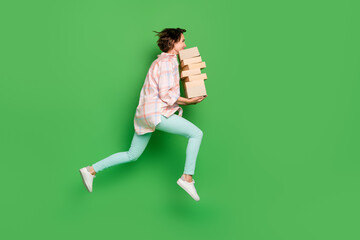 Full length photo of brunette bob haired woman jump up hold hands box delivery empty space isolated on green color background