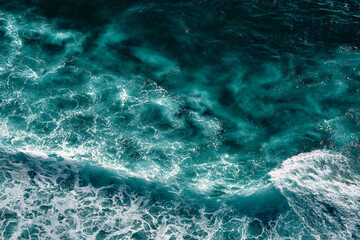 Aerial view to seething waves with foam. Waves of the sea meet each other during high tide and low tide
