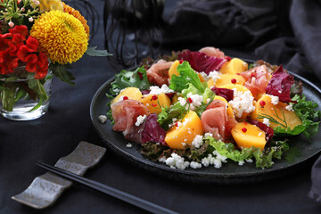 Persimmon and prosciutto ham autumn appetizer salad for Halloween or Thanksgiving....