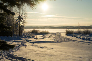 winter landscape with snow, sun, blue sky and snowy trees