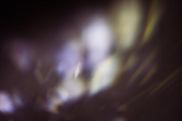 Blur colorful cold rainbow light leaks on black background with dust texture. Defocused abstract damaged scratched retro film analog effect for using over photos as overlay or screen filter
