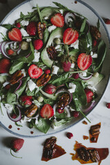 salad with strawberries, avocado, cheese and nuts