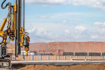 Powerful hydraulic drilling rig on a construction site. Installation of bored piles by drilling....
