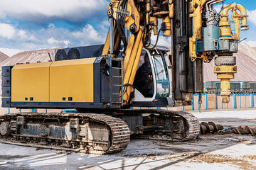 Powerful hydraulic drilling rig on a construction site. Installation of bored piles by drilling. Pile foundations. Drilling in the ground.