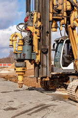 Powerful hydraulic drilling rig on a construction site. Installation of bored piles by drilling. Pile foundations. Drilling in the ground.