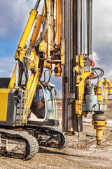 Powerful hydraulic drilling rig on a construction site. Installation of bored piles by drilling. Pile foundations. Drilling in the ground.