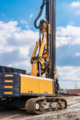 Powerful hydraulic drilling rig on a construction site. Installation of bored piles by drilling. Pile foundations. Drilling in the ground.