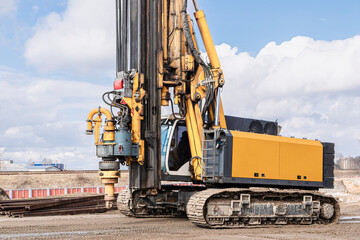 Powerful hydraulic drilling rig on a construction site. Installation of bored piles by drilling. Pile foundations. Drilling in the ground.