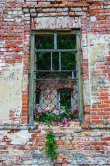 Fototapeta na wymiar an old window in the brick wall of an abandoned church