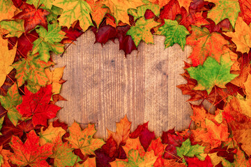Naklejka na ściany i meble Textured vintage rustic wooden background with autumn leaves