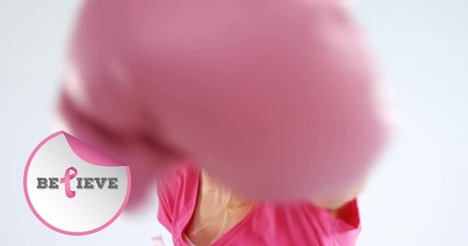 Animation of breast cancer awareness text over female boxer