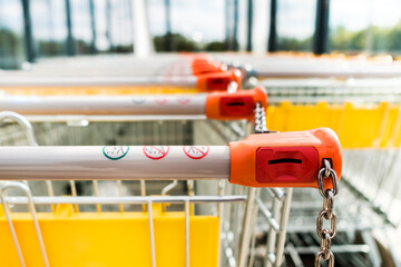 Shopping carts of a supermarket in a row, close up - 458889840