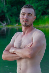 Sexy Portrait of Handsome Topless Male Model on the Beach. 
Summer Relax. Portrait Of Athletic Sexy Man With Muscular Body Handsome Fitness Male Model on Sunset.