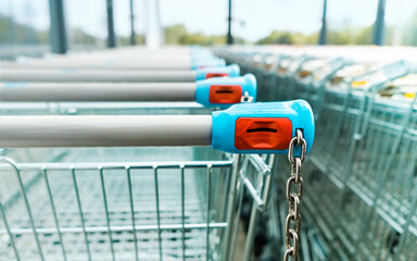 Shopping carts of a supermarket in a row, close up - 458889865
