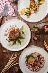 Italian meat, poultry and seafood dishes on a wooden table