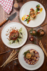 Italian meat, poultry and seafood dishes on a wooden table