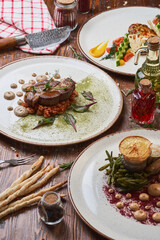 Italian meat, poultry and seafood dishes on a wooden table