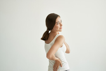 woman in white t-shirt joint pain treatment health light background