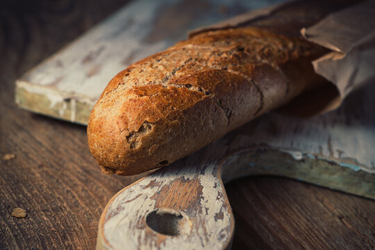 Freshly baked French baguette on a wooden background